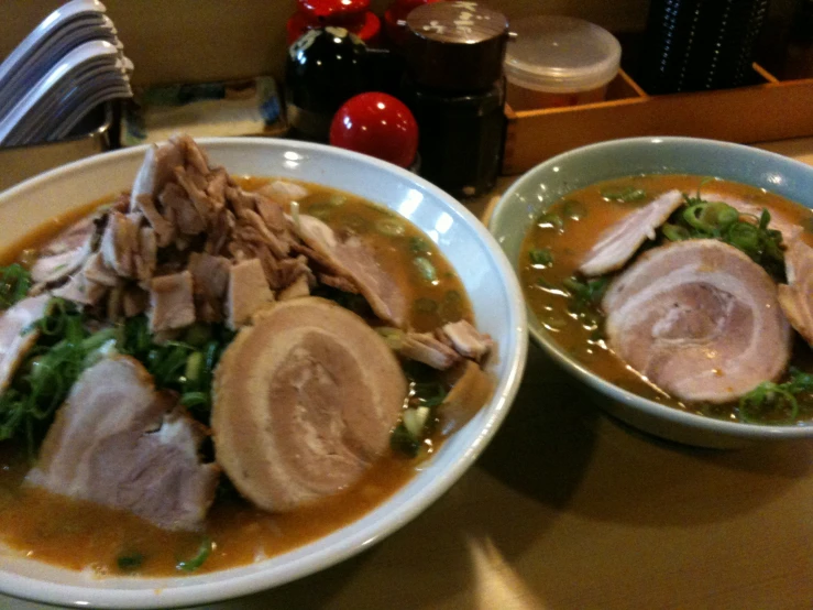 two bowls of soup are on a table