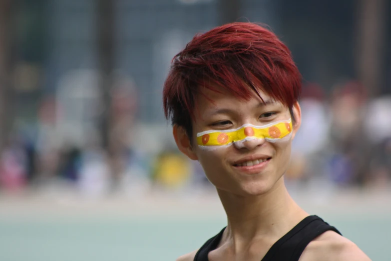 a woman with red hair and a fake mask