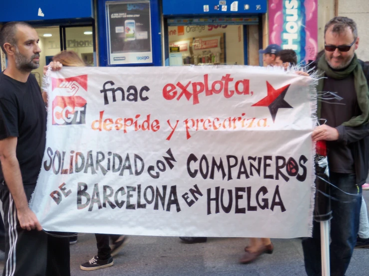 men are holding an up sign protesting