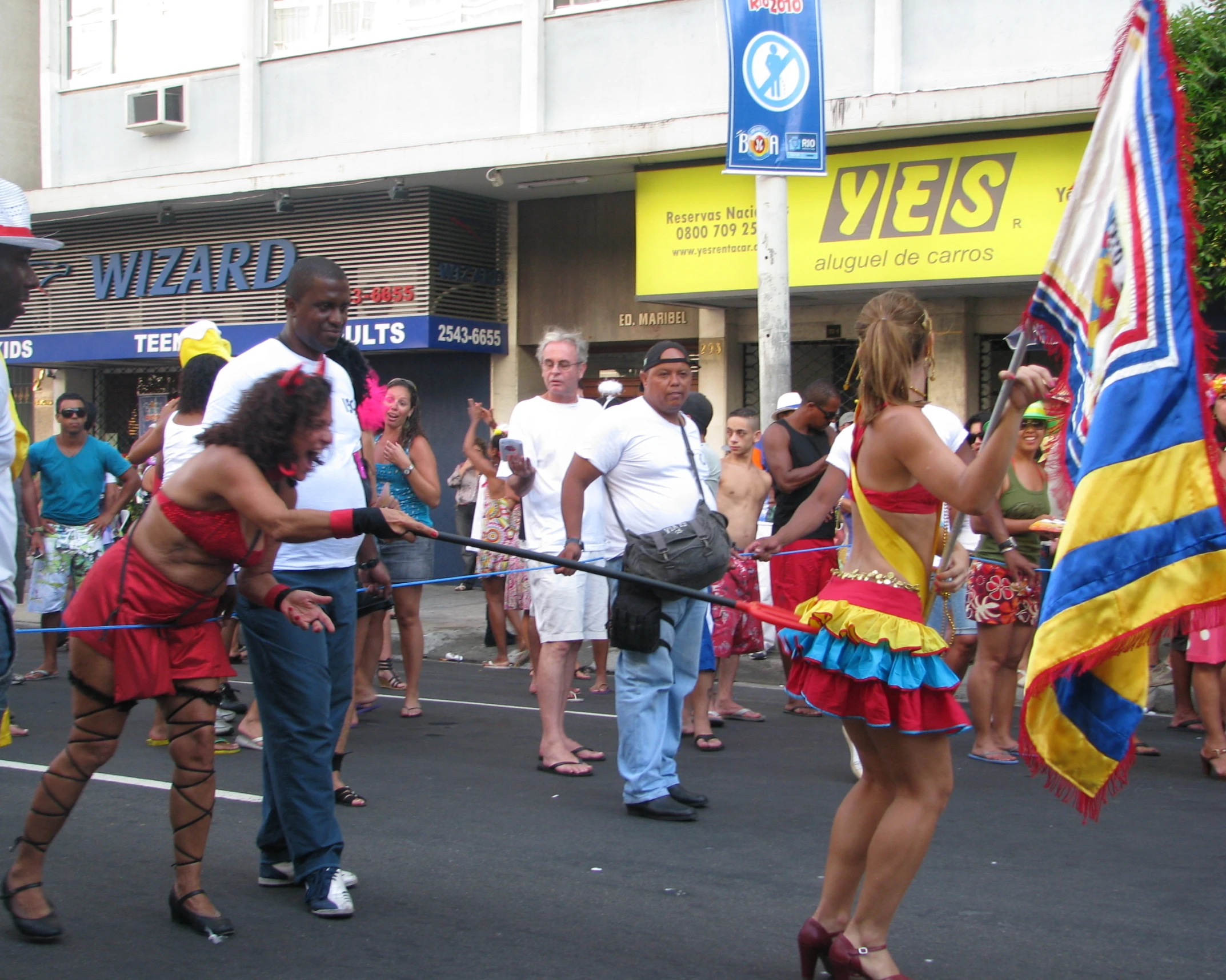 a group of people standing around a street with flags