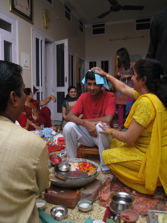 people sit at an indian table to eat food