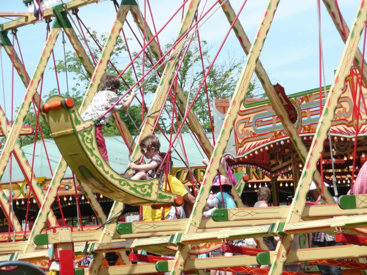 children playing on the carousels at a carnival