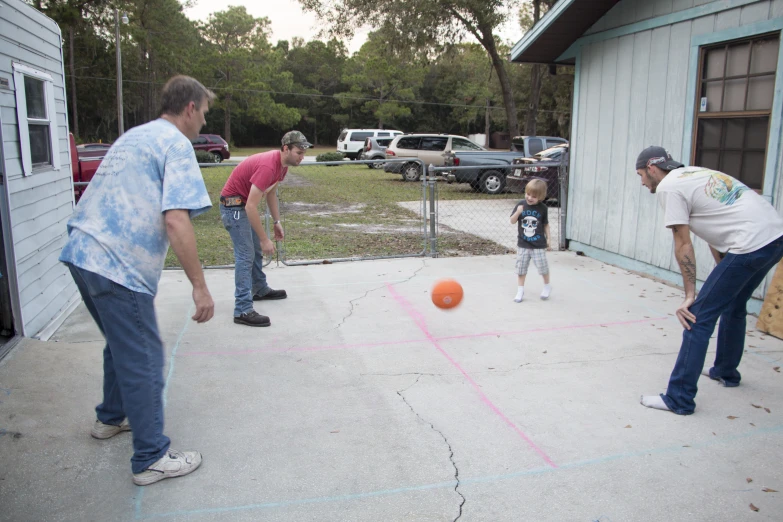 a man and a little girl playing a game of tennis with a coach