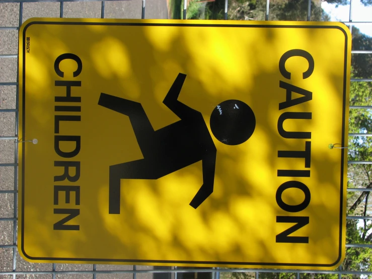 a yellow caution sign warning children about the dangers of walking