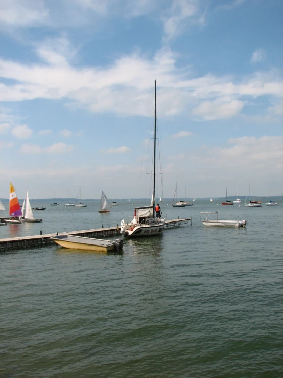 an image of sailboats in the water at anchor