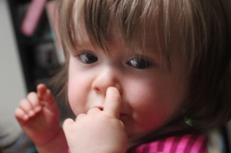 a child brushing its teeth in a room