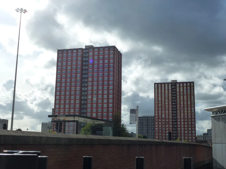 a row of large buildings against a cloudy sky