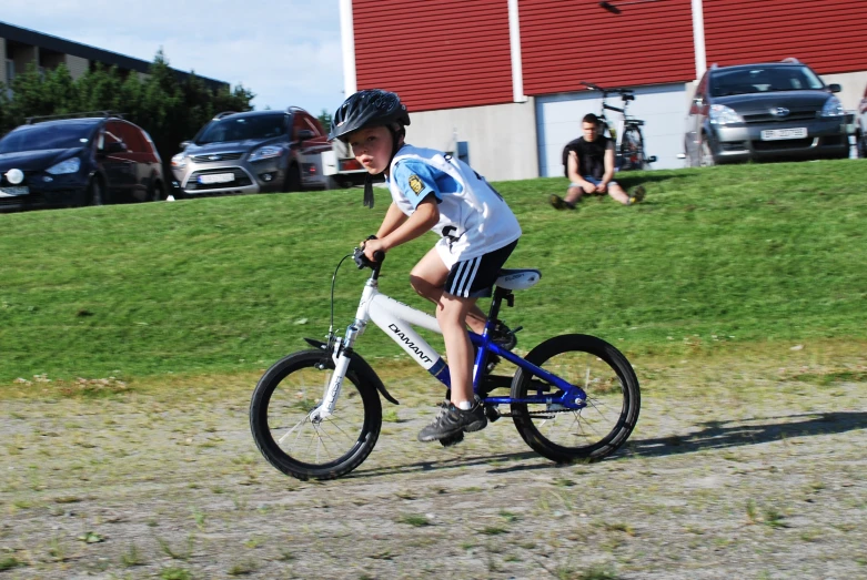 a boy riding a small bicycle on a path