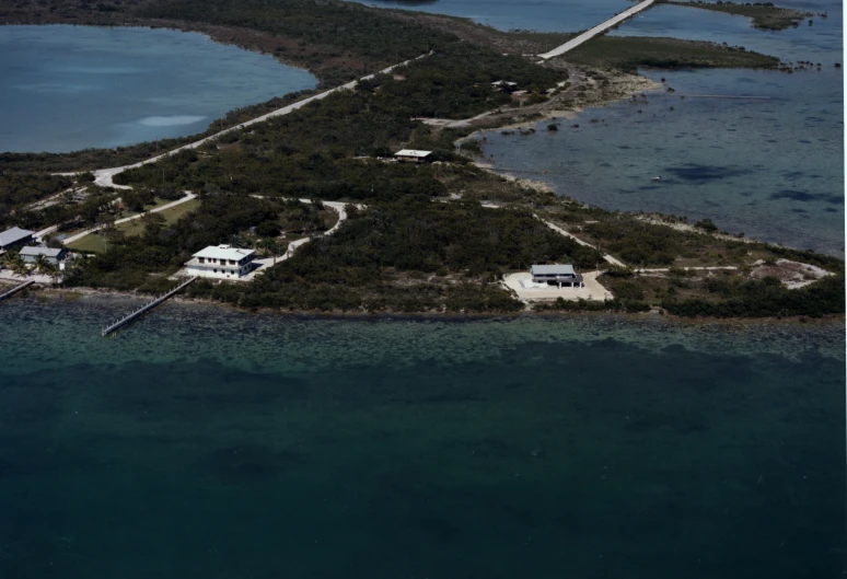 an aerial po of a home on an island near the ocean