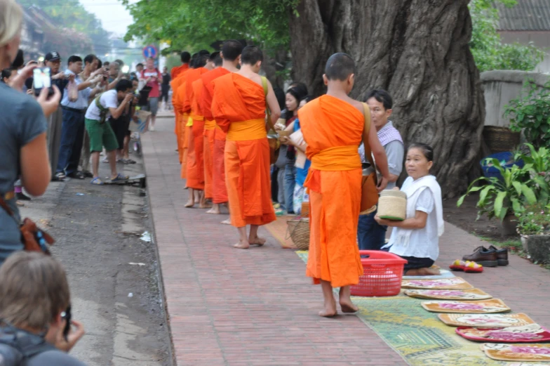 a crowd of people stand near some baskets