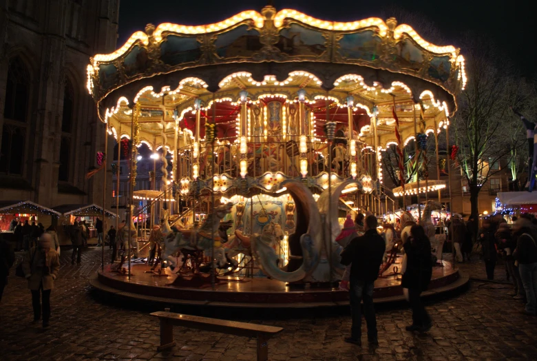 a merry go round with lights and people in it