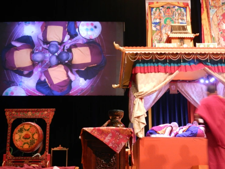 a video game showing a puppet show in an old style setting