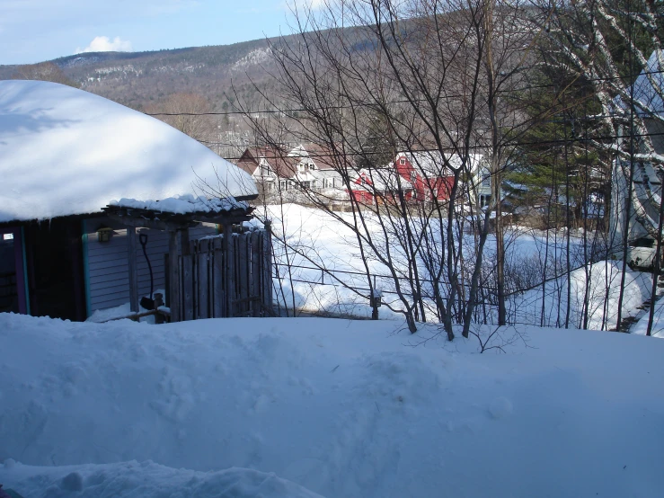 a snow covered hill with a hut on top