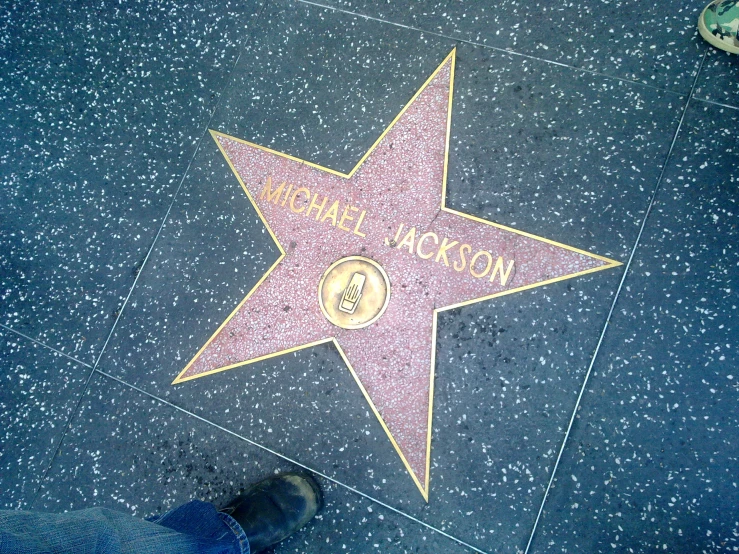 a person on top of a hollywood walk of fame star