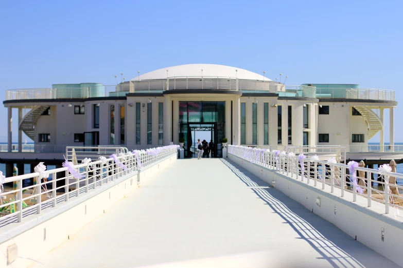 people are standing on a deck outside a building