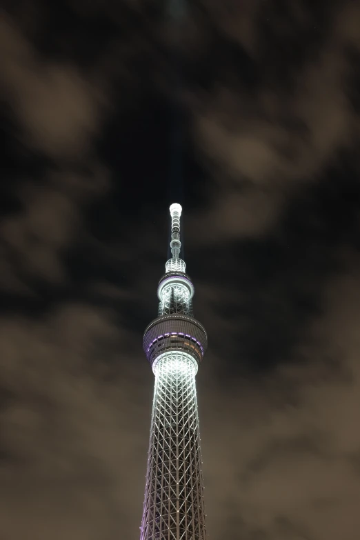 a tall tower with a clock on top against a cloudy sky