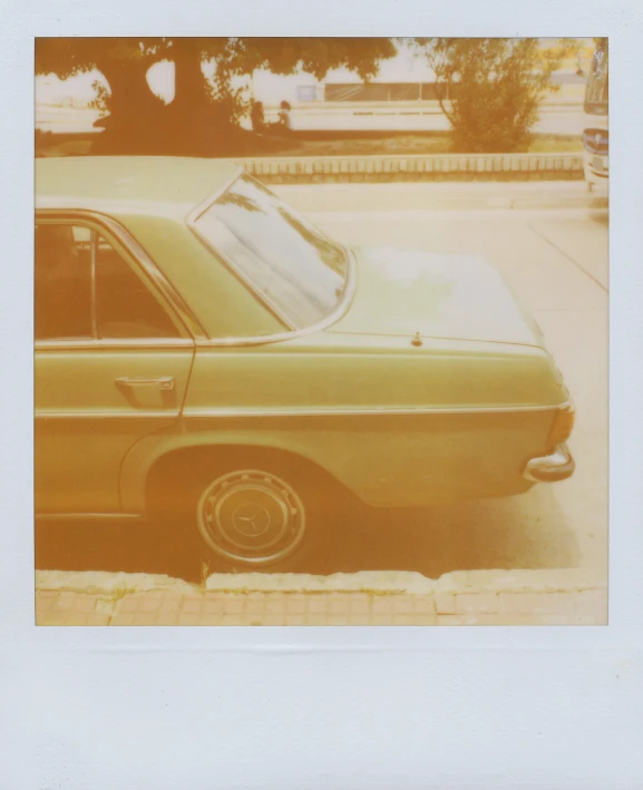 old model car with tinted window on sidewalk