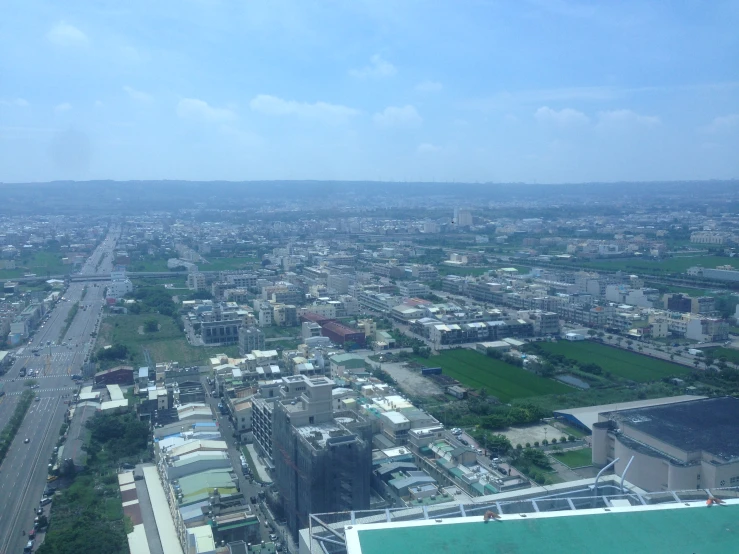 a view of a large city and a field from a helicopter