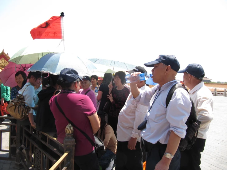 people in uniform are standing around with umbrellas