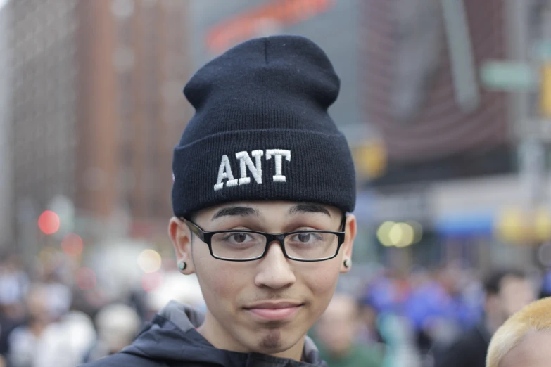 a close up of a person wearing glasses and a beanie