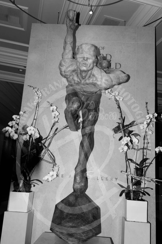 a statue with flowers and some vases