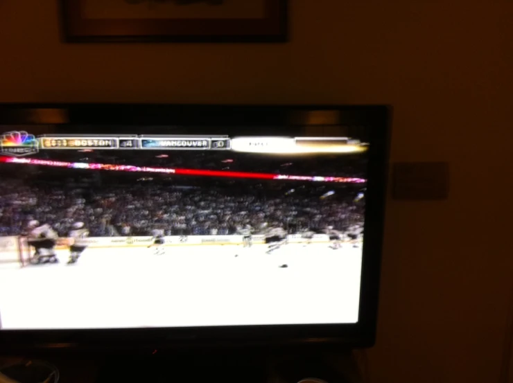 a large screen tv showing a hockey game