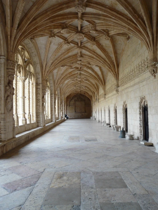 a large stone walkway with a long cathedral ceiling