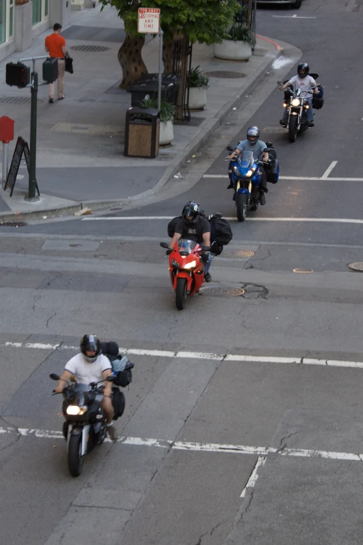 several motorcycles are riding around on a street