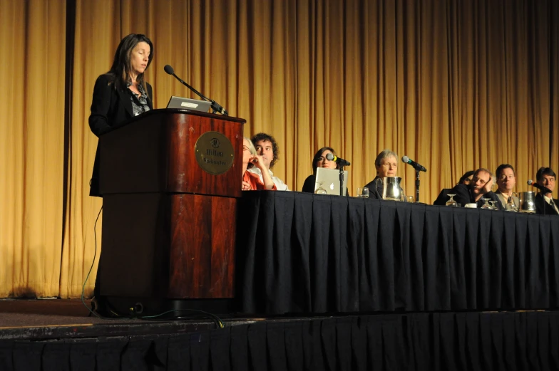 several people are gathered at a podium for an award