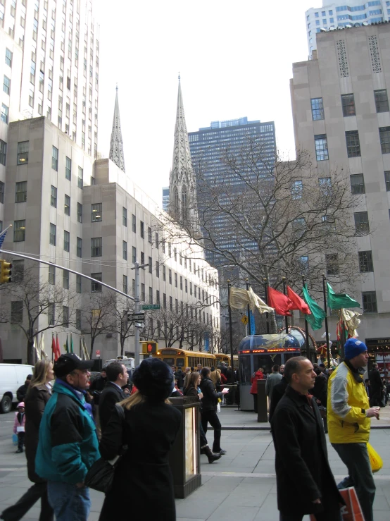 the large crowd of people walk down the city street