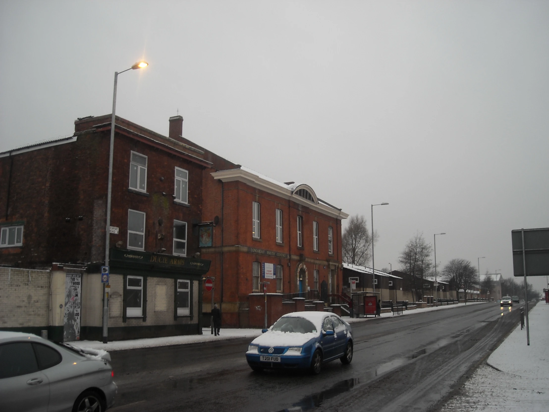 cars going on a city street in the winter