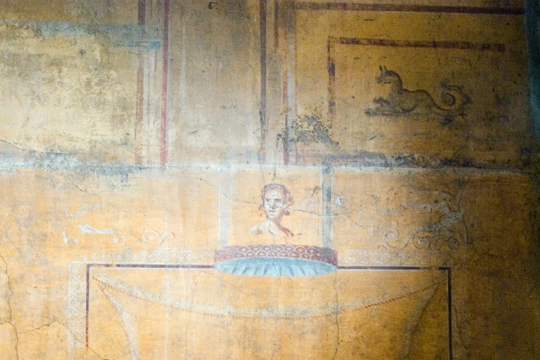 ancient painted wall panels in a room with gold paint