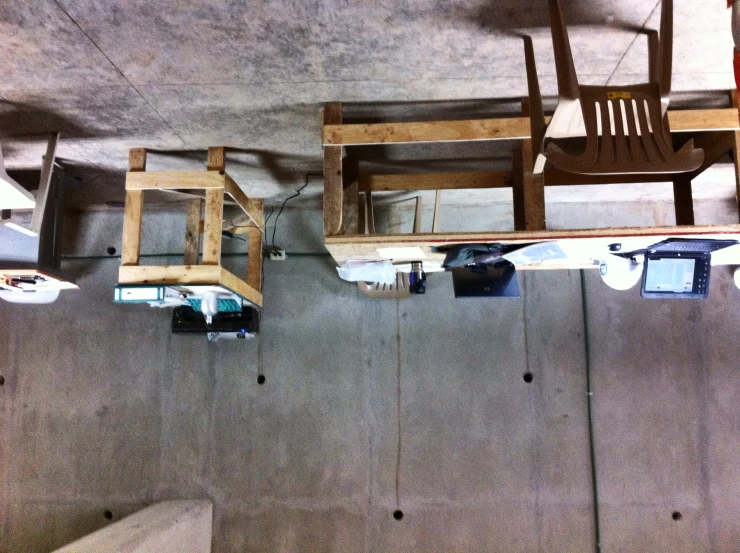 a row of laptop computers sitting on top of wooden desks