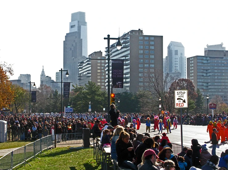 the parade is filled with many people and some buildings