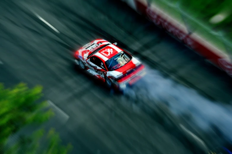 a race car driving through a track on its way to a red start