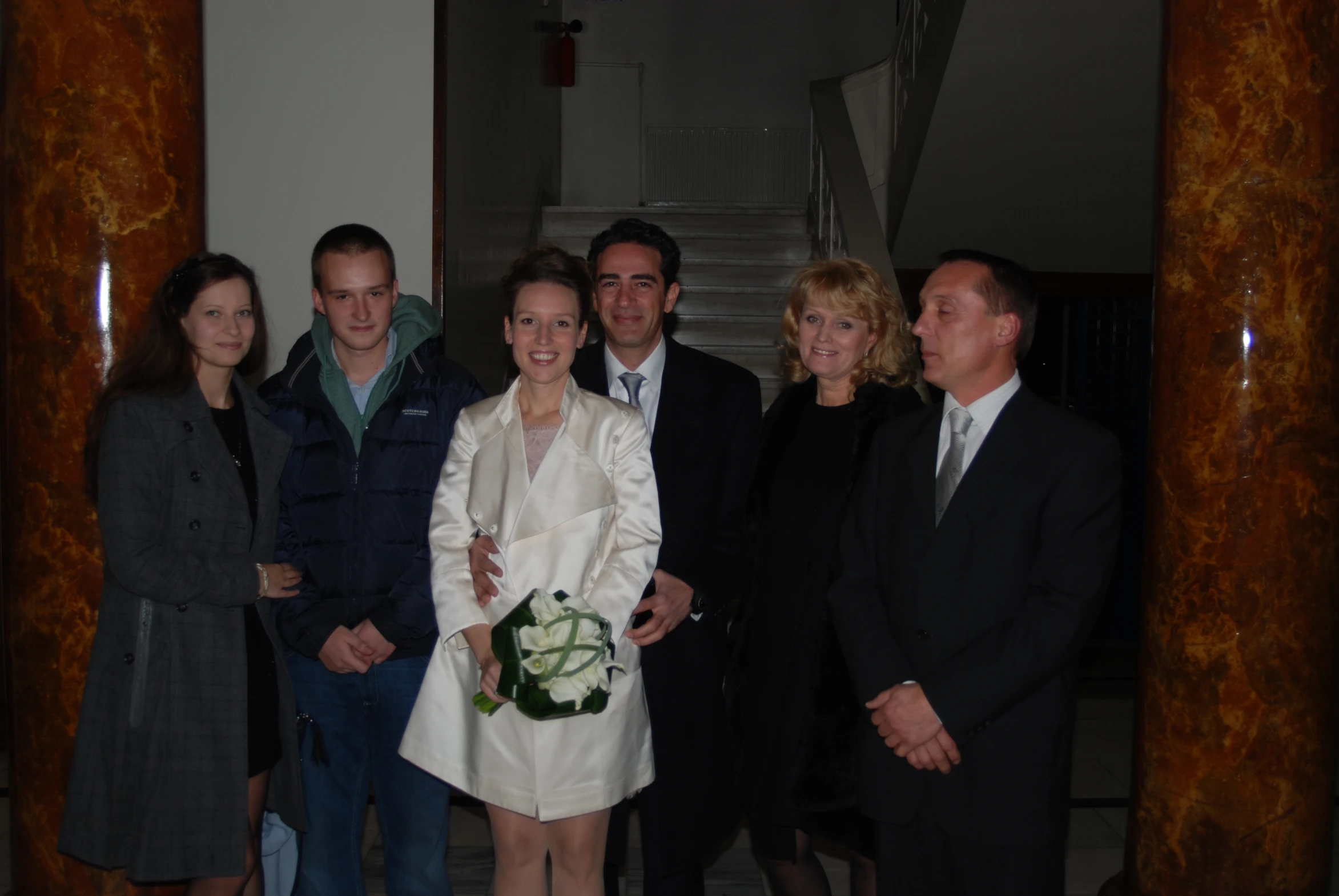 a group of people in suits and ties are posing for a picture