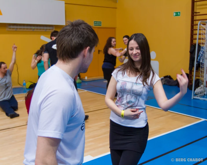 the young man and woman are discussing a sport program