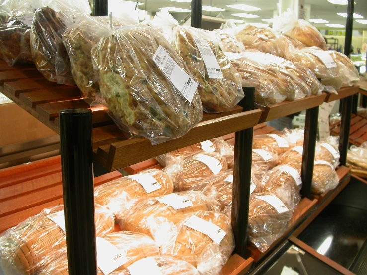 some breads are lined up on racks with the covers over