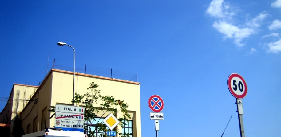 some traffic signs that are outside a building