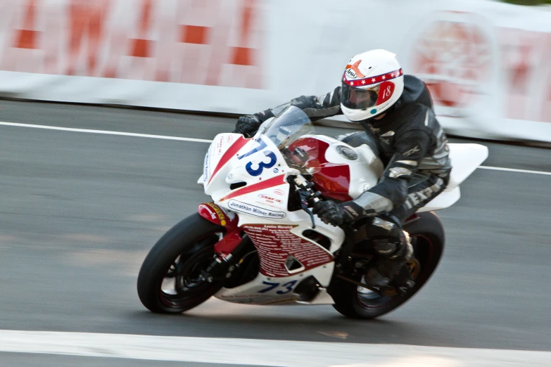 a man on a motorbike riding around a corner