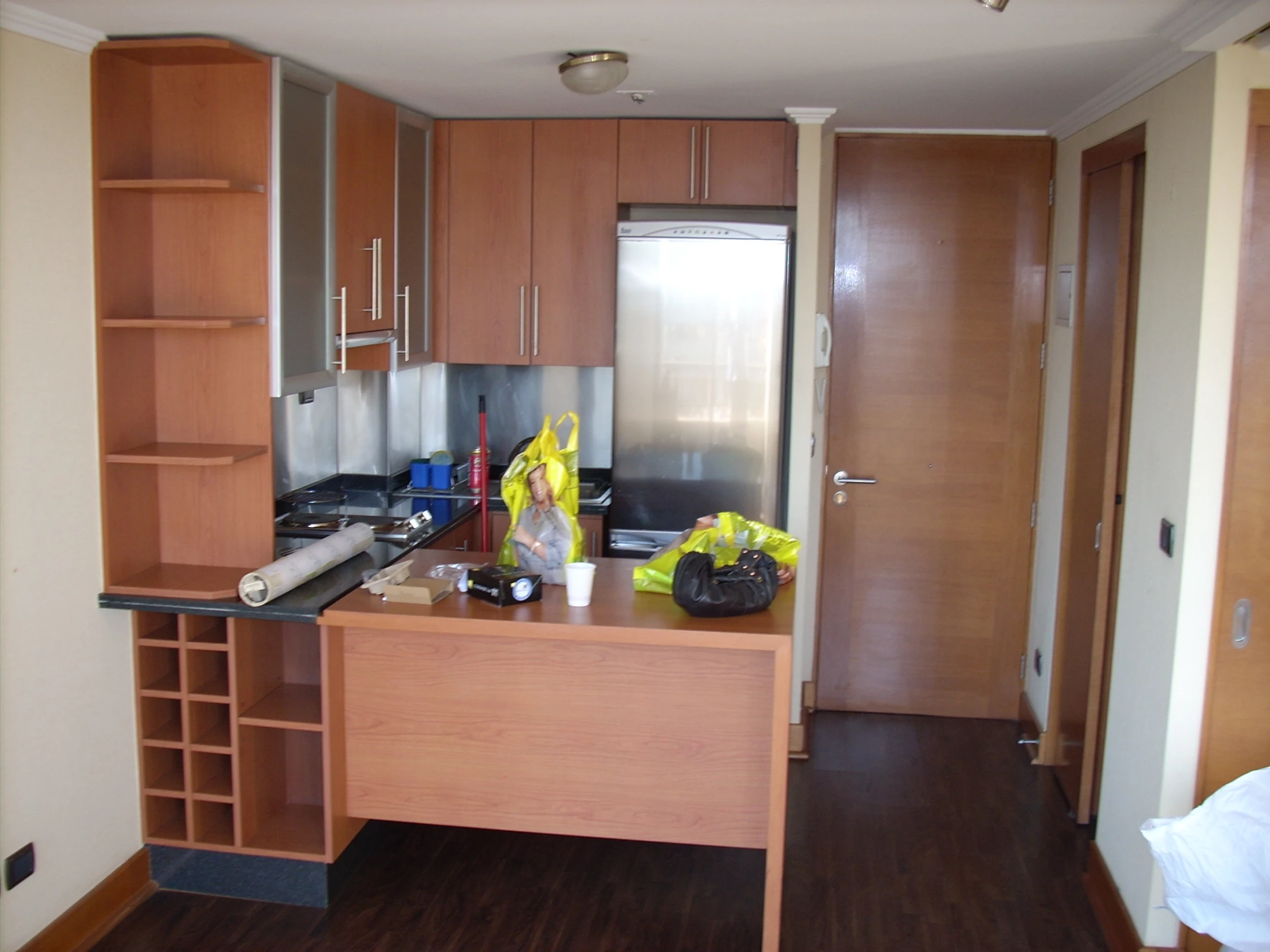 an empty kitchen with an island made of wood