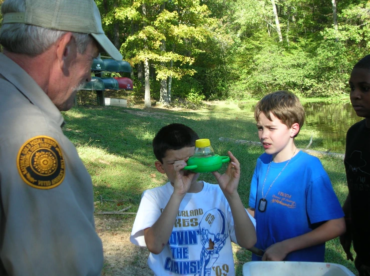 a group of young children are standing around each other