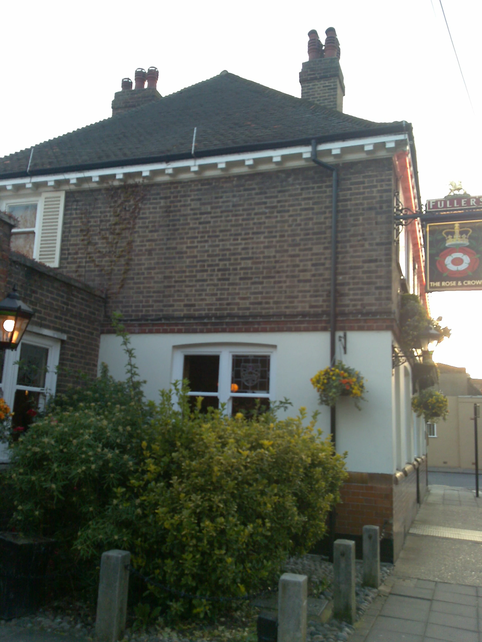 a house has a brick exterior and flowers