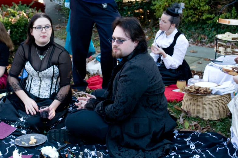 people dressed in costume sit around at the park