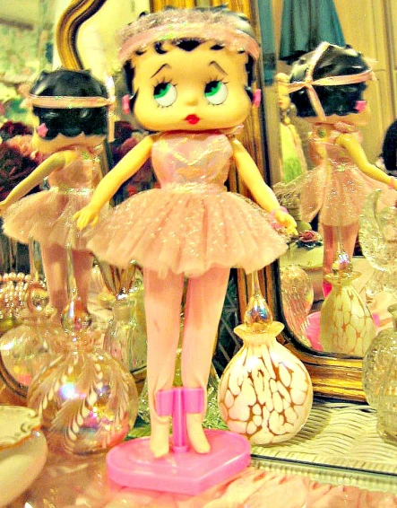 a display of decorative ballerina figures and other memorabilia