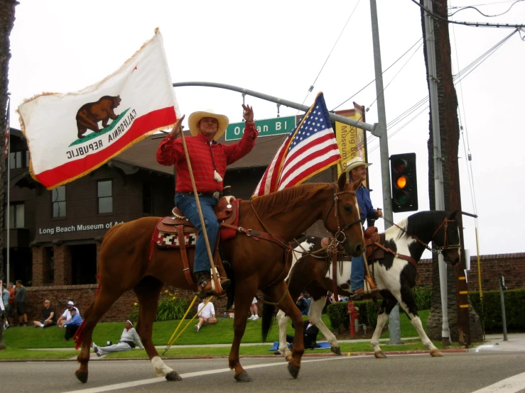 a person rides on a horse with two flags