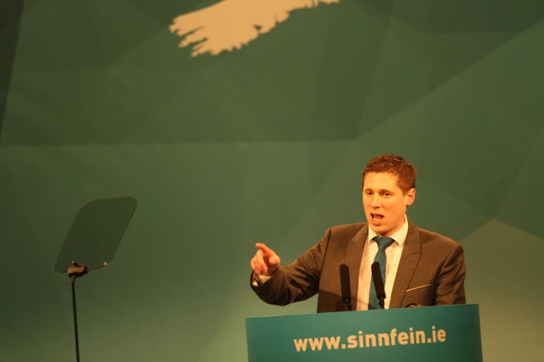 a man standing behind a podium at a convention