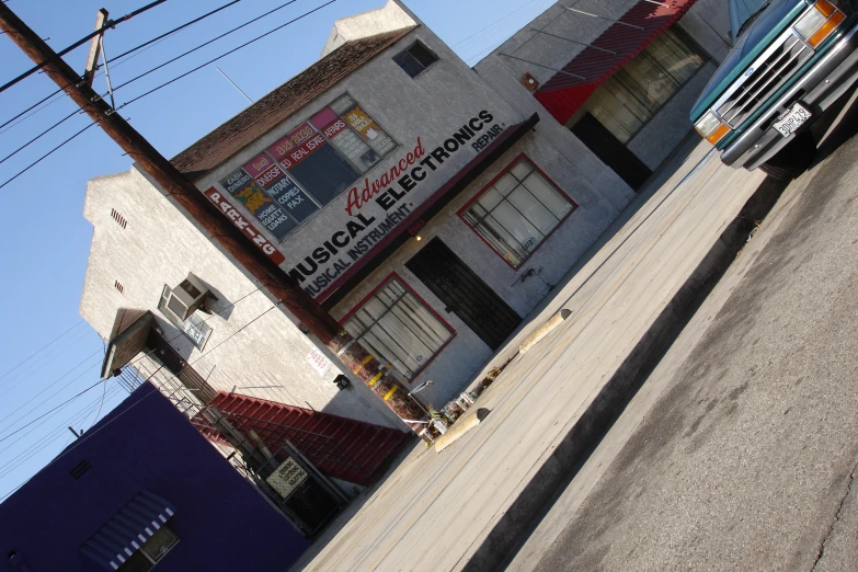 a car is parked in front of a commercial store