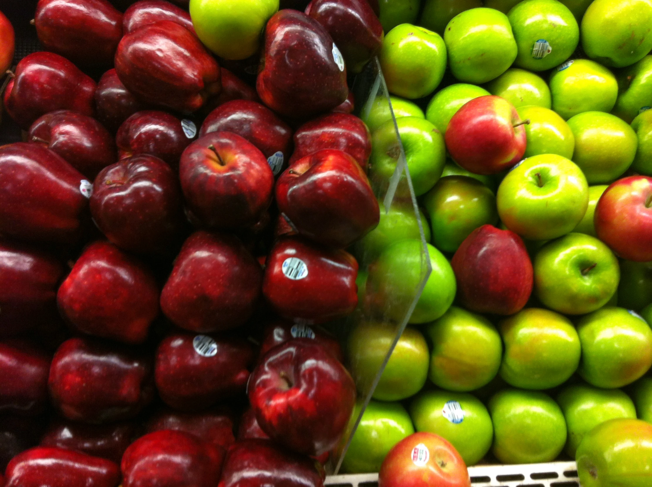 an assortment of colorful apples at a grocery store