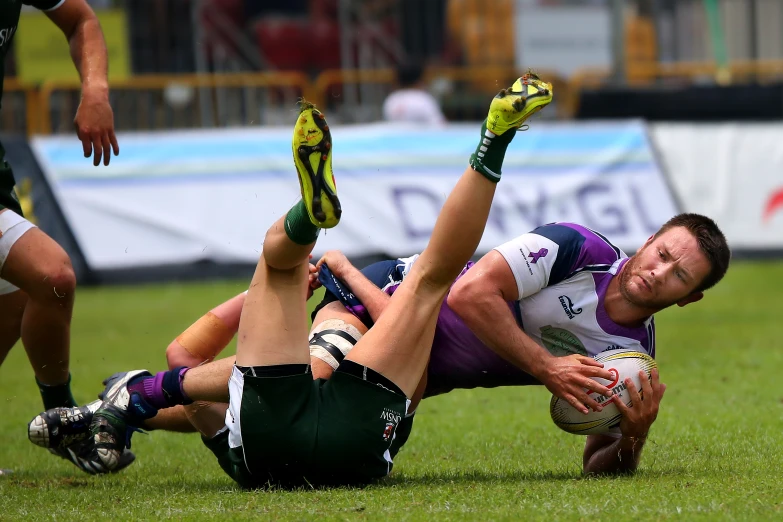 a rugby player tries to get past the other players